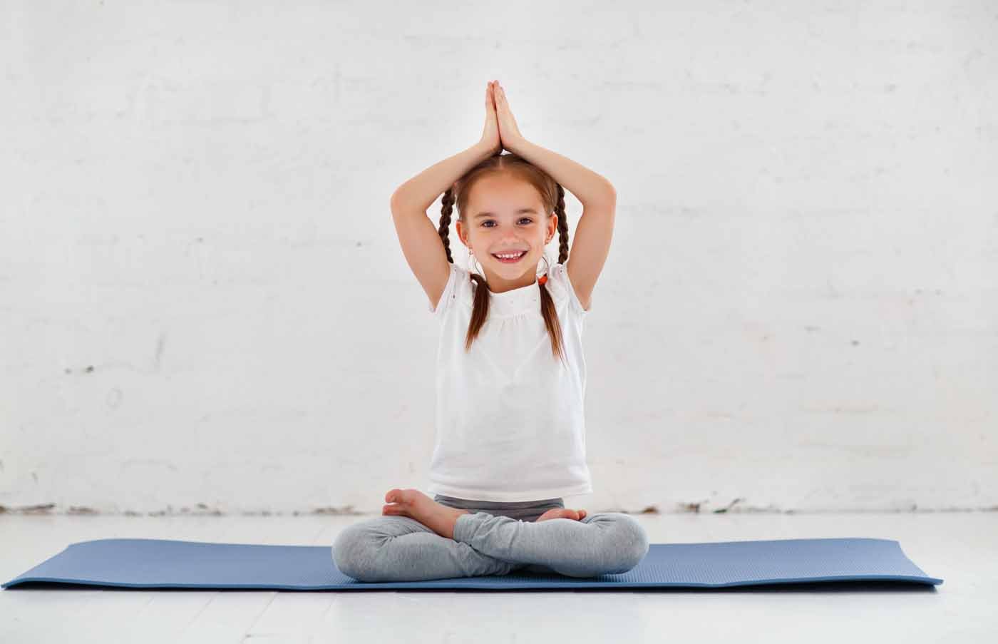 child girl doing yoga and gymnastics in the gym